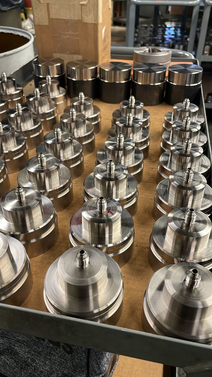 Tray of machined stainless parts with threaded fittings